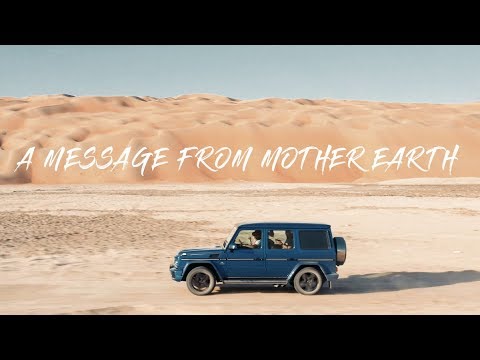 Off-road vehicle crossing a desert landscape in an aerial film still