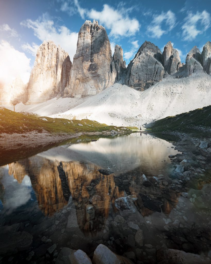 Alpine lake reflecting jagged Dolomite peaks