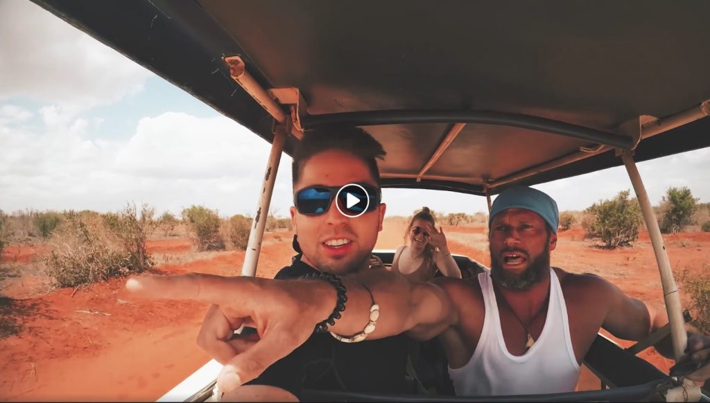 Three travelers riding in an open safari vehicle