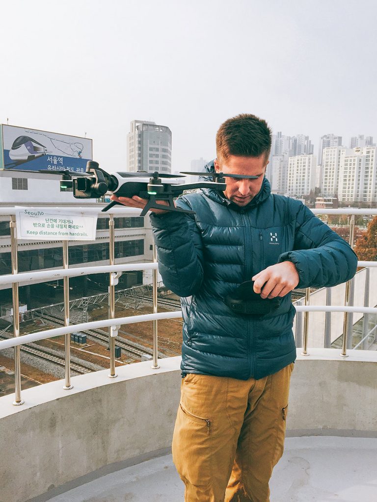 Presenter checking a microphone during a rooftop shoot