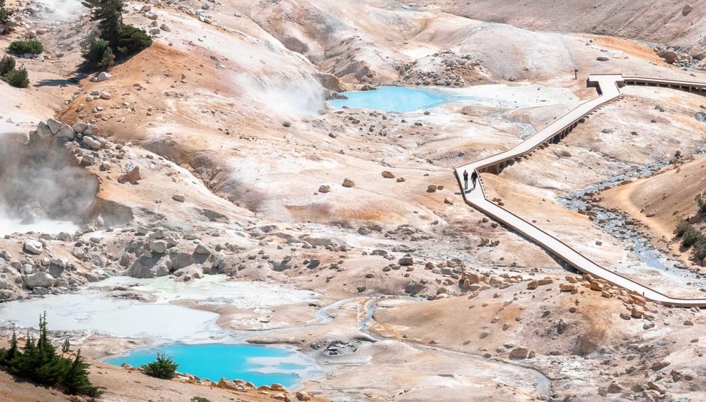 Boardwalk winding past turquoise pools at Bumpass Hell
