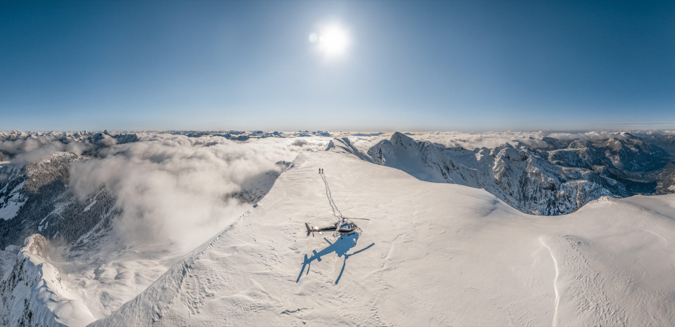 49 North Helicopters flying over a snow-covered ridge on Vancouver Island