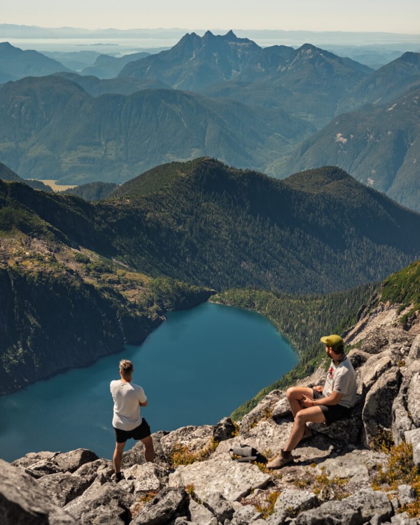 Hikers overlooking an alpine lake reached by helicopter