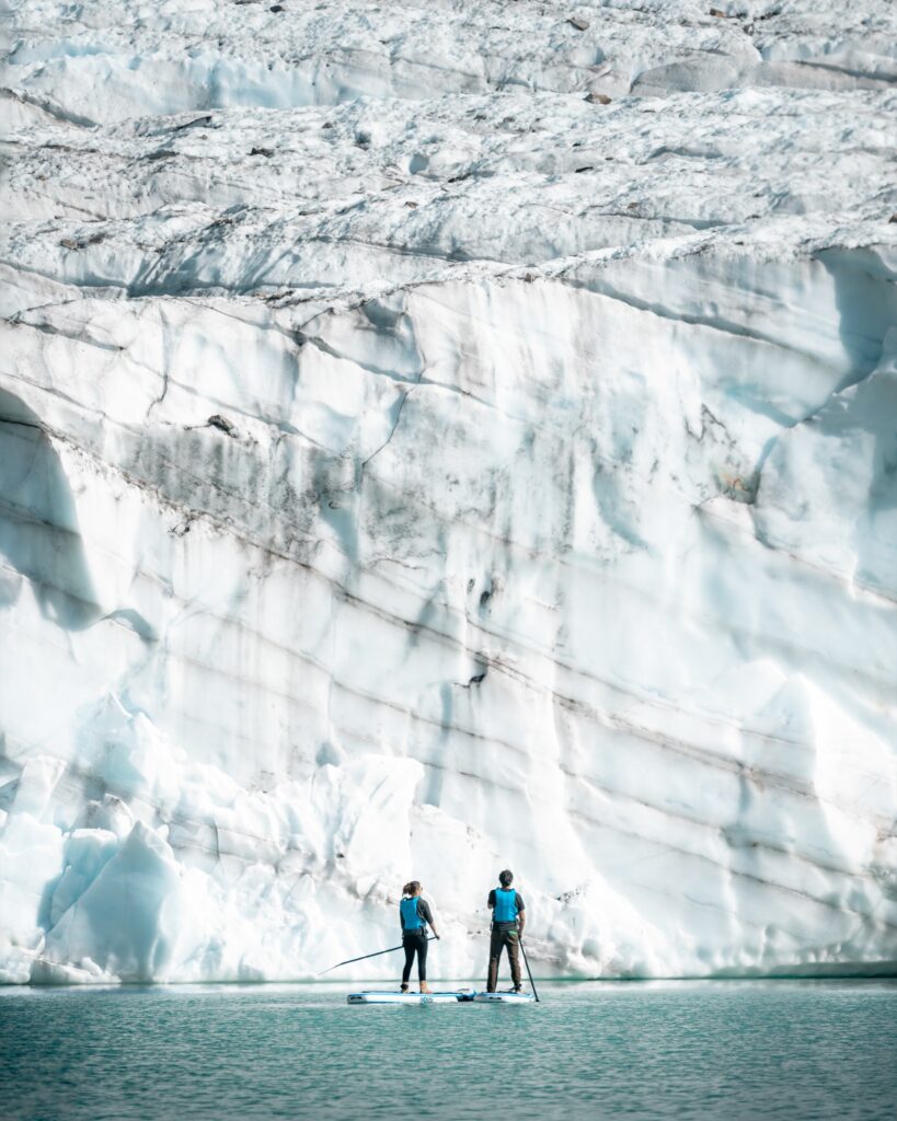 Guests exploring the face of a glacier during a helicopter adventure
