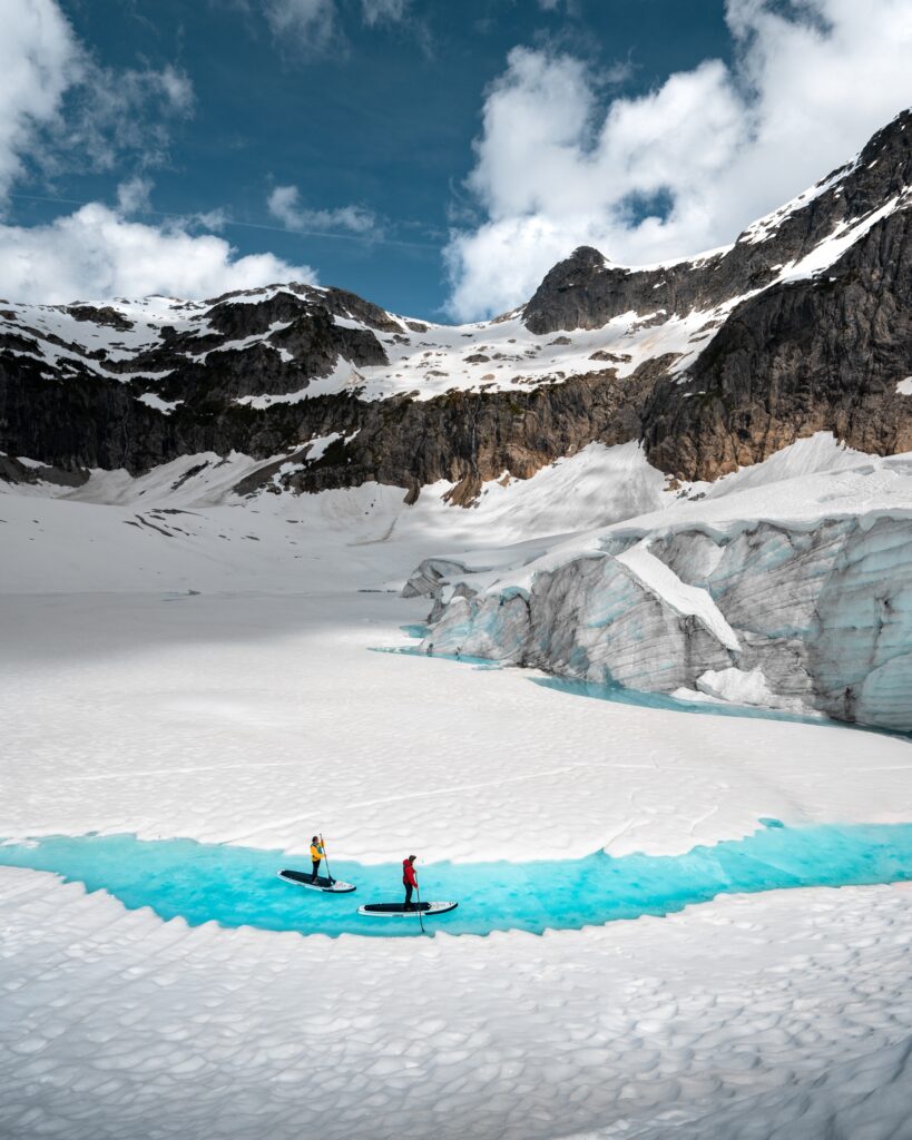 Blue glacier ice and meltwater in the mountains