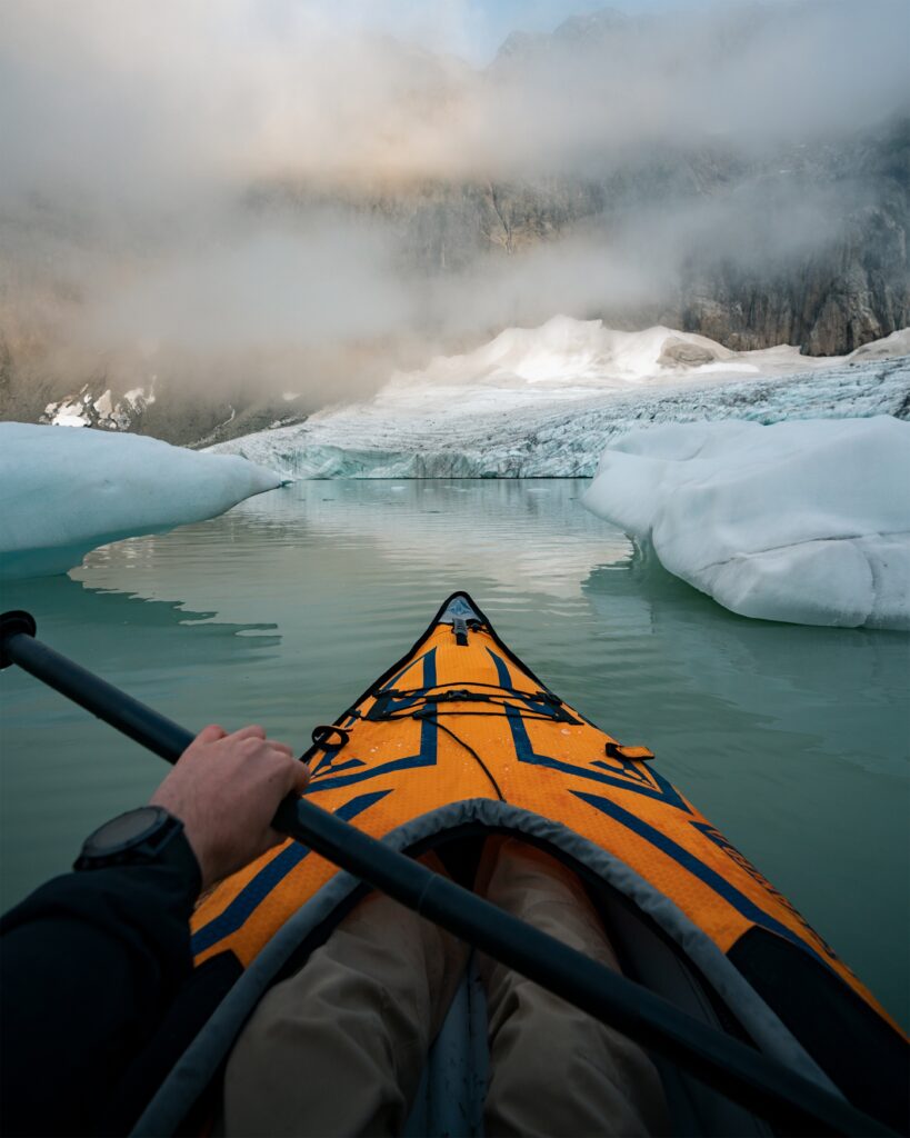 Kayak moving through a glacier lagoon