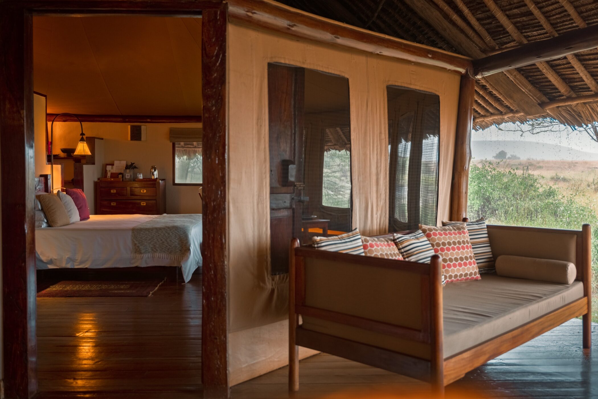 Safari lodge bedroom opening onto a private terrace in Kenya