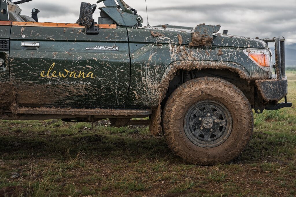 Weathered safari vehicle marked Elewana in the Kenyan bush