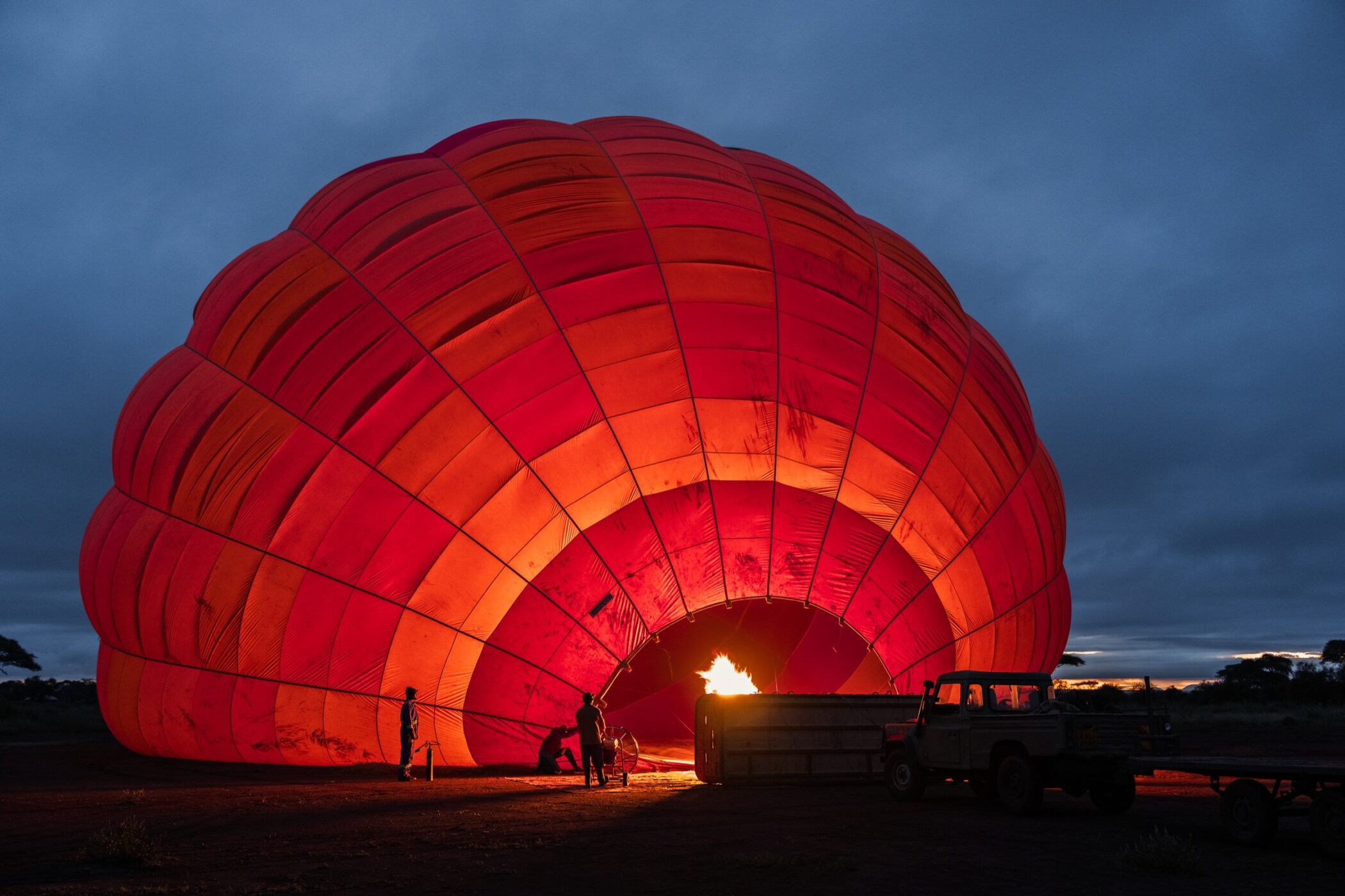 Hot-air balloon glowing before a dawn safari flight in Kenya
