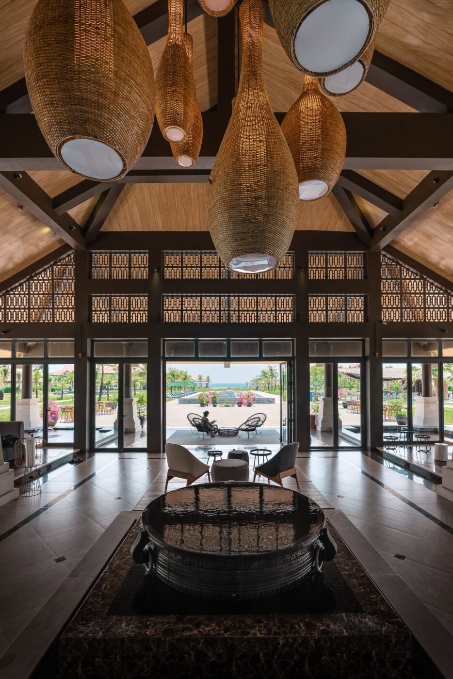 Open hotel architecture and reflective water at Nam Hoi