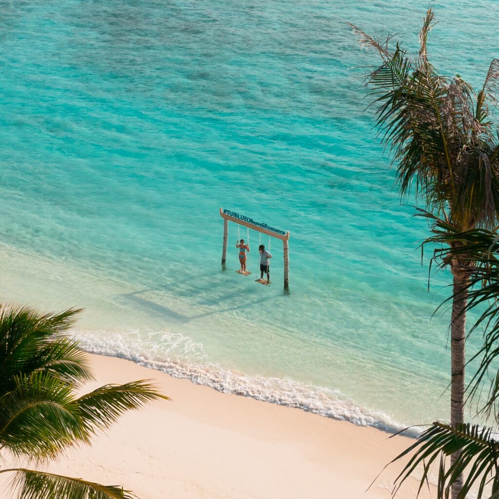 Beach swing beside the clear lagoon at Olhuveli