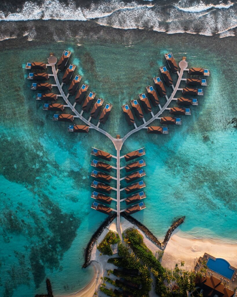 Overwater villas extending into a turquoise lagoon in the Maldives
