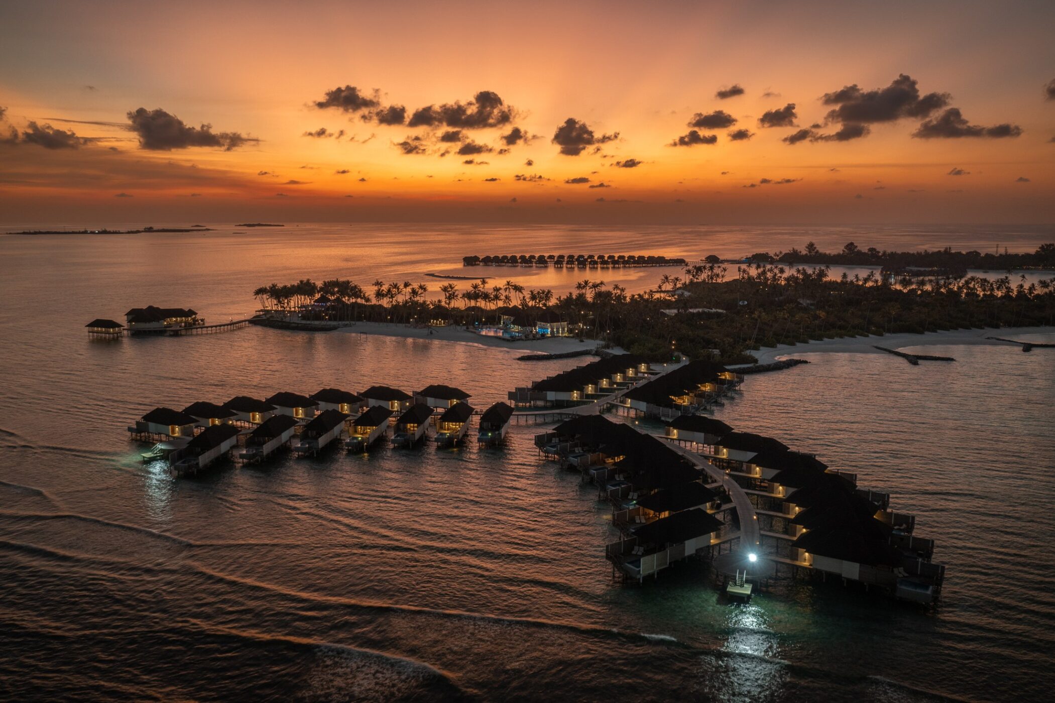 Overwater villas at Olhuveli in the Maldives at sunset