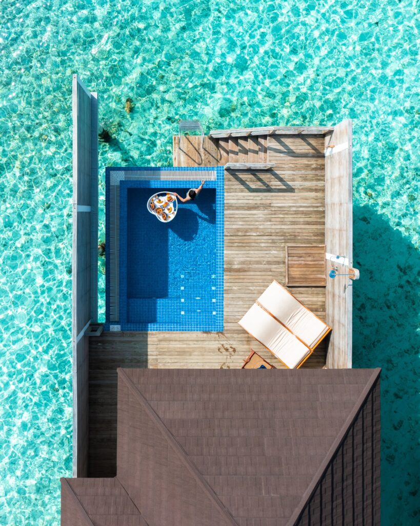 Private pool villa surrounded by turquoise water at Olhuveli