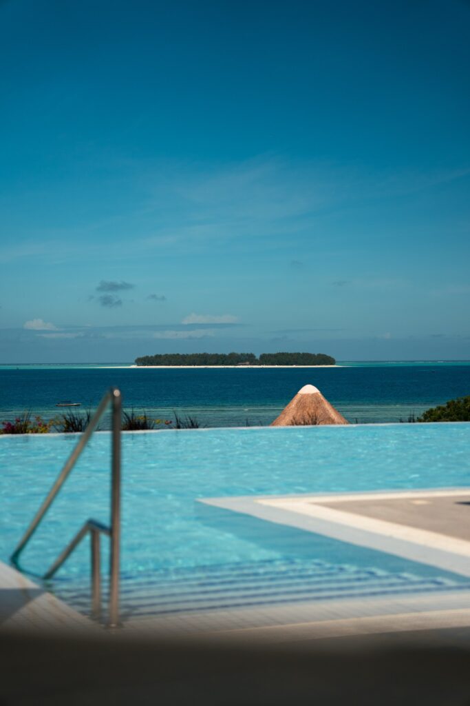 Infinity pool framed by tropical greenery at The Mora Zanzibar