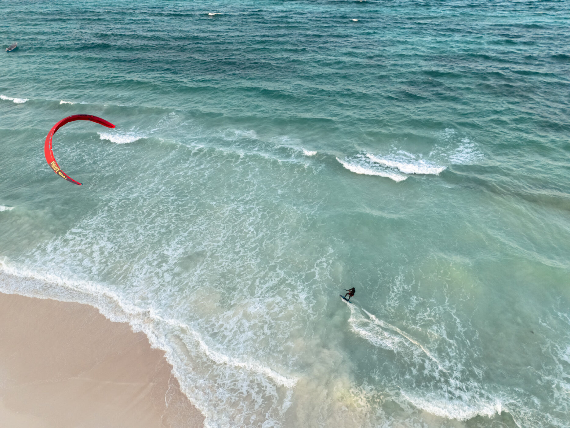 Kitesurfer riding along the beach near The Mora Zanzibar