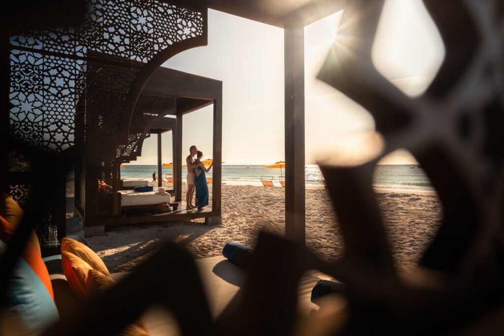 Couple relaxing in an open-air lounge at The Mora Zanzibar