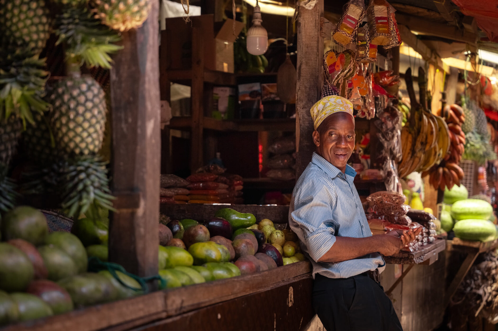 Produce vendor at a colourful Stone Town market in Zanzibar