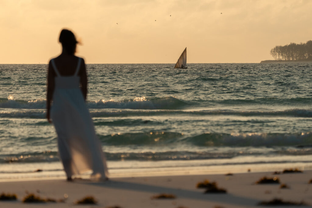 Dhow sailing past The Mora Zanzibar at sunrise