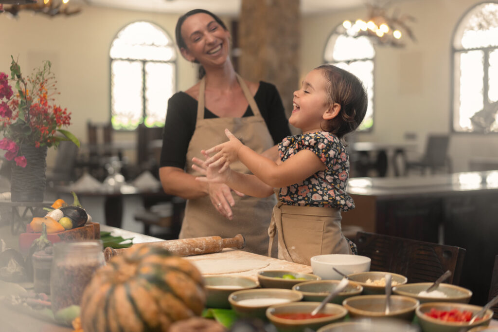 Mother and child sharing a Swahili cooking experience at The Mora Zanzibar