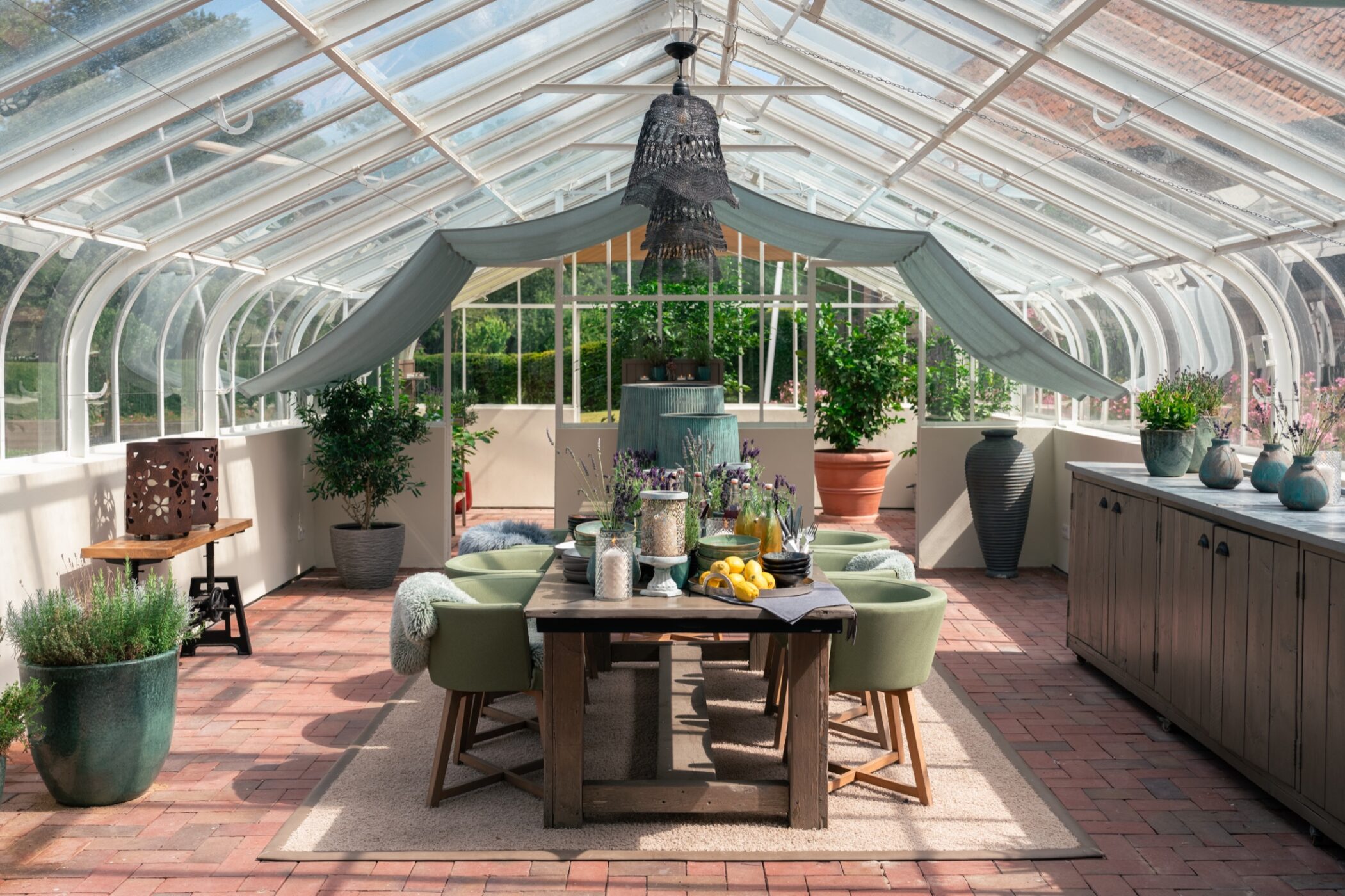 Glass greenhouse dining space at WEISSENHAUS resort