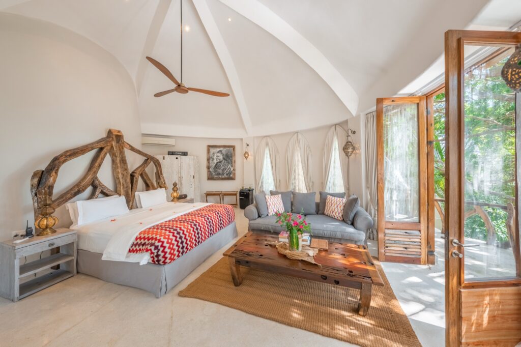 Bright arched bedroom at Villa Alfajiri in Zanzibar
