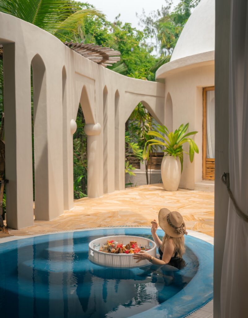 Guest with floating breakfast in a private plunge pool