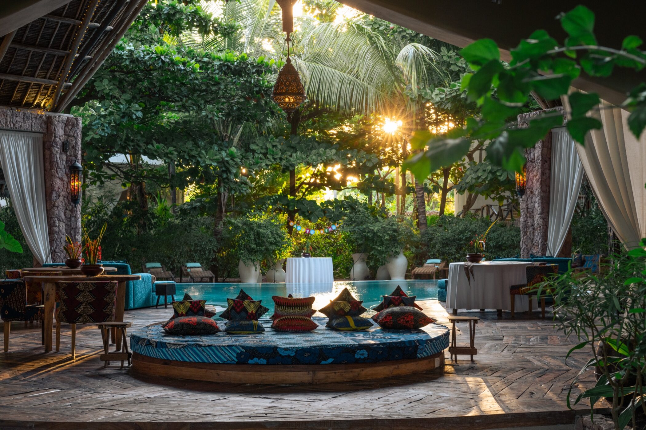 Guests relaxing in a shaded outdoor lounge at Xanadu Villas