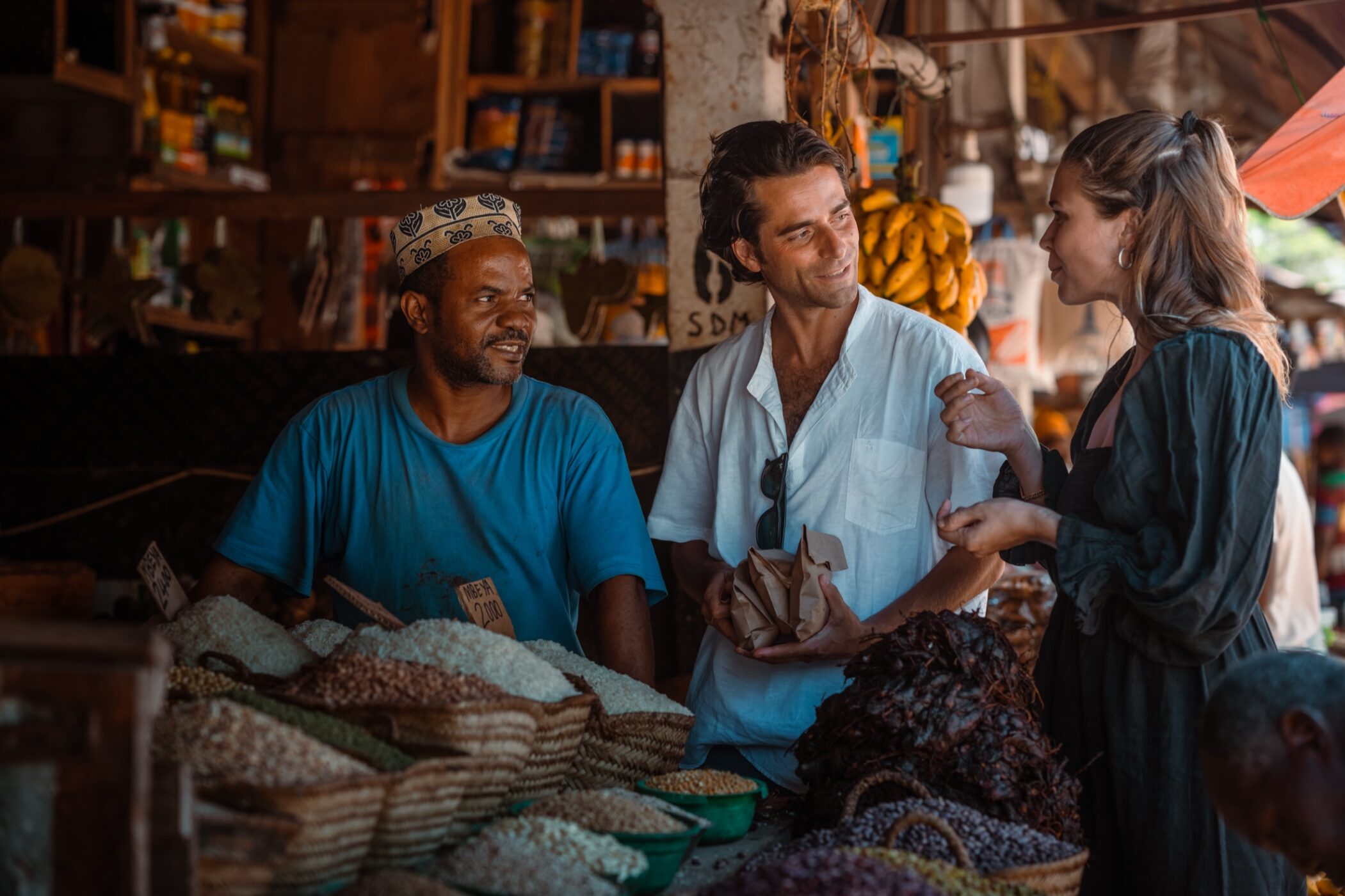 Guests speaking with a vendor at a Zanzibar market