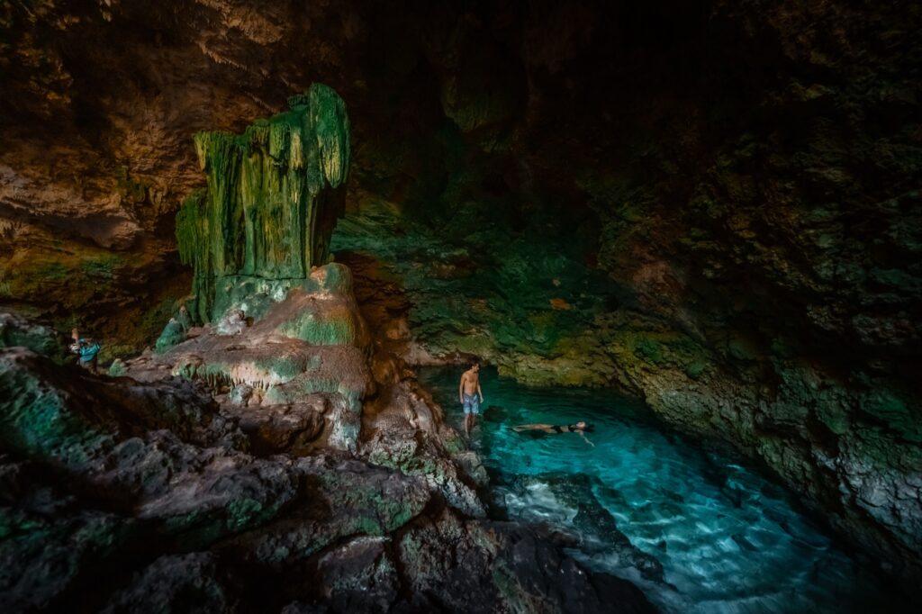 Guests swimming in a turquoise cave during a Zanzibar excursion